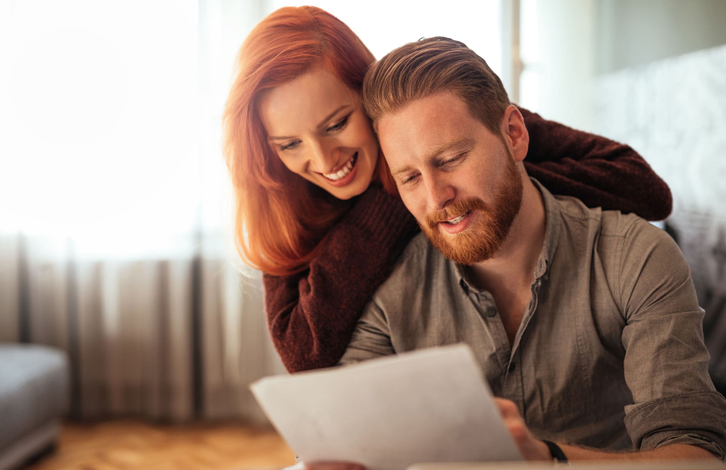 Smiling couple reviewing bank statement