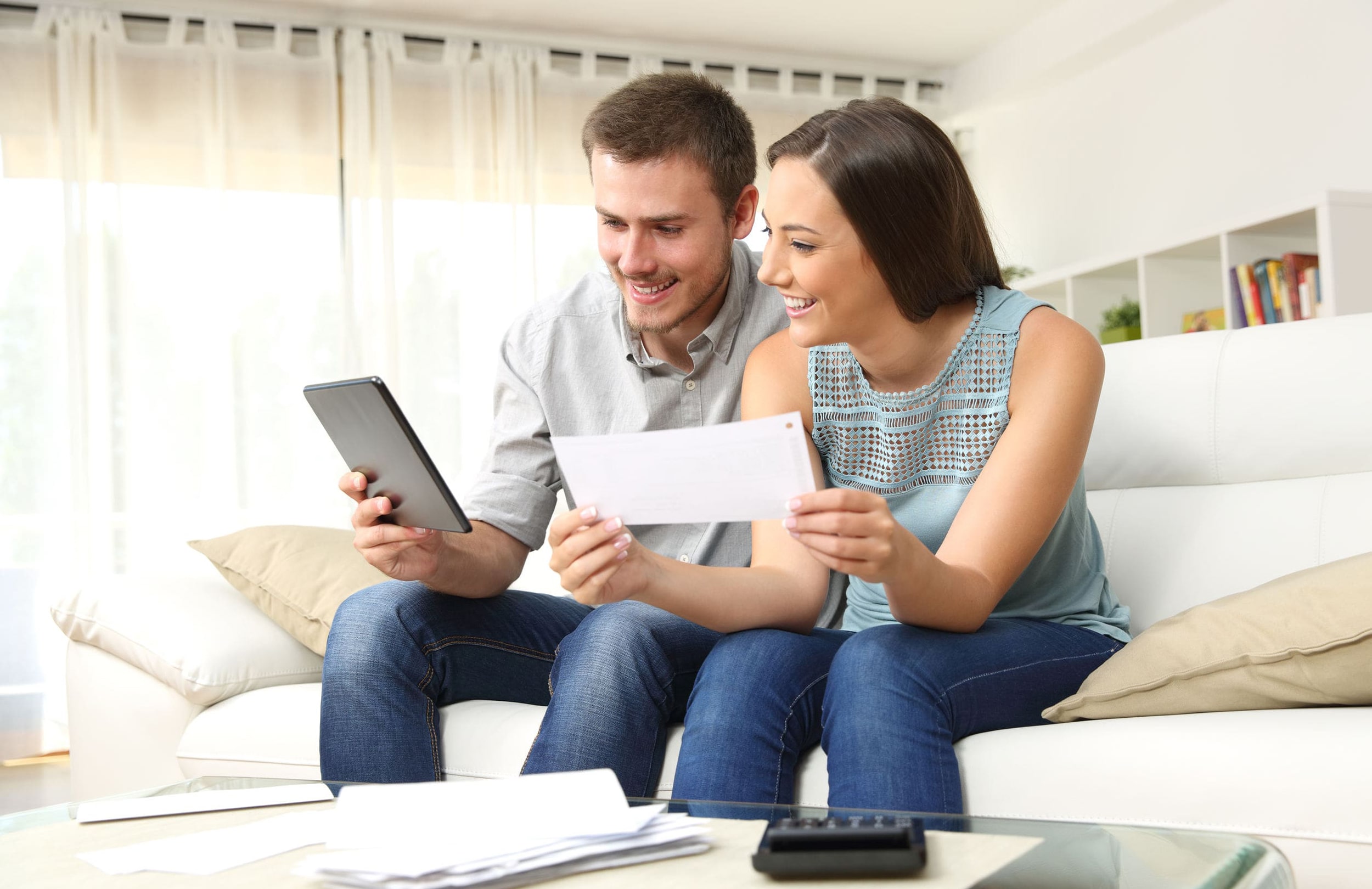 Smiling couple reviewing savings account statement