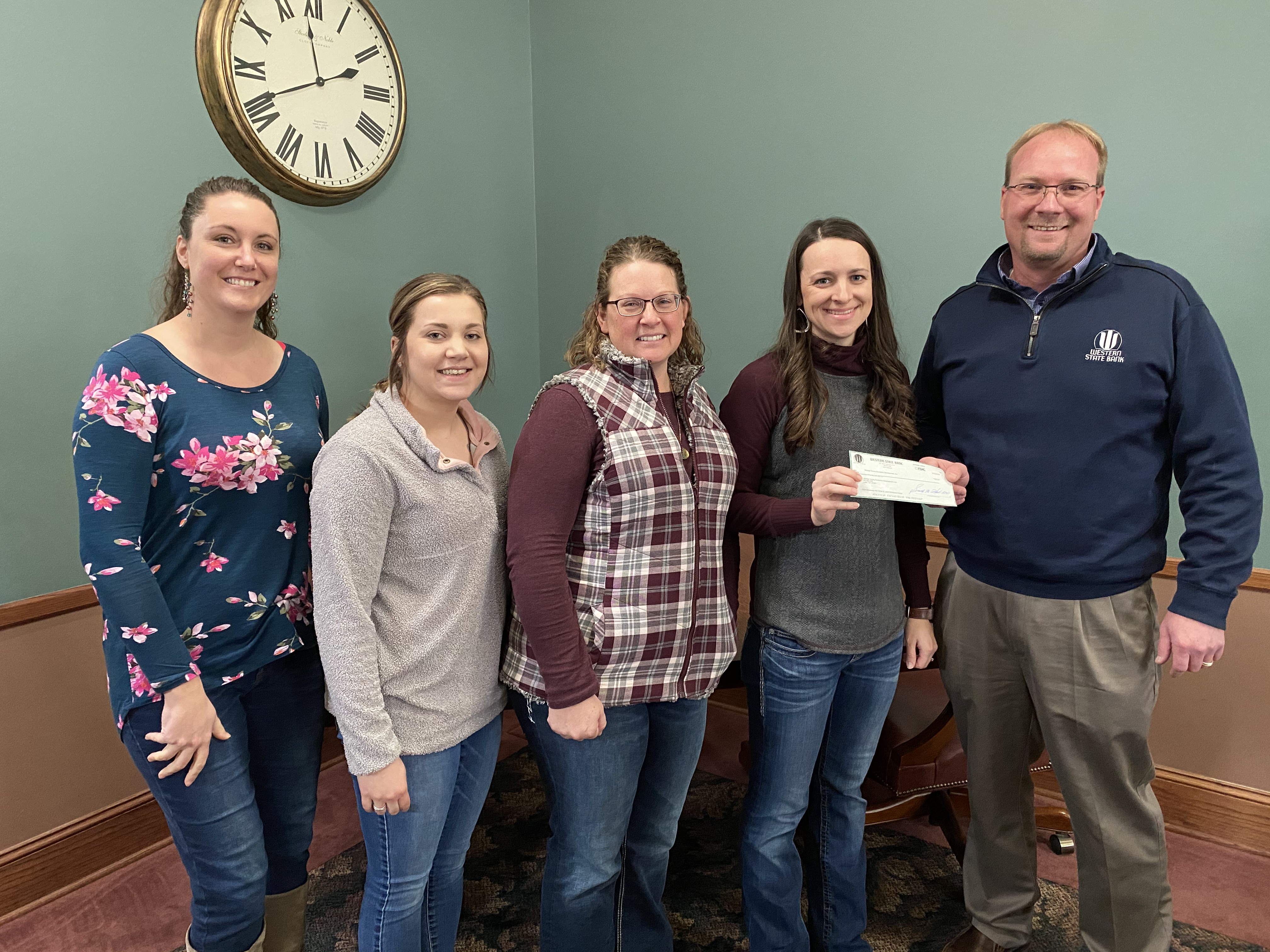 Western State Bank Leoti Brady Harbin presents check to Wichita County Grow & Learn