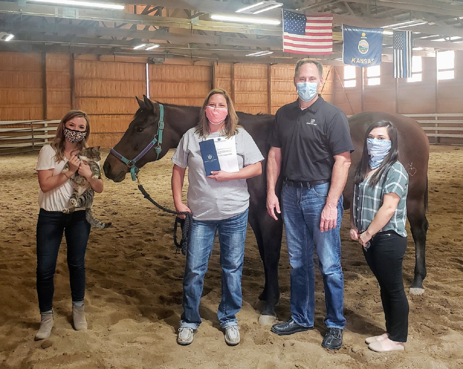 Garden City employees present check to representative from Miles of Smiles