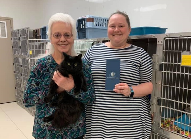 Garden City employee presents a check to FCHS employee