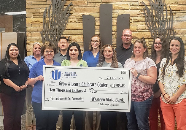 Leoti bank staff presents check to Grow & Learn Childcare Center board