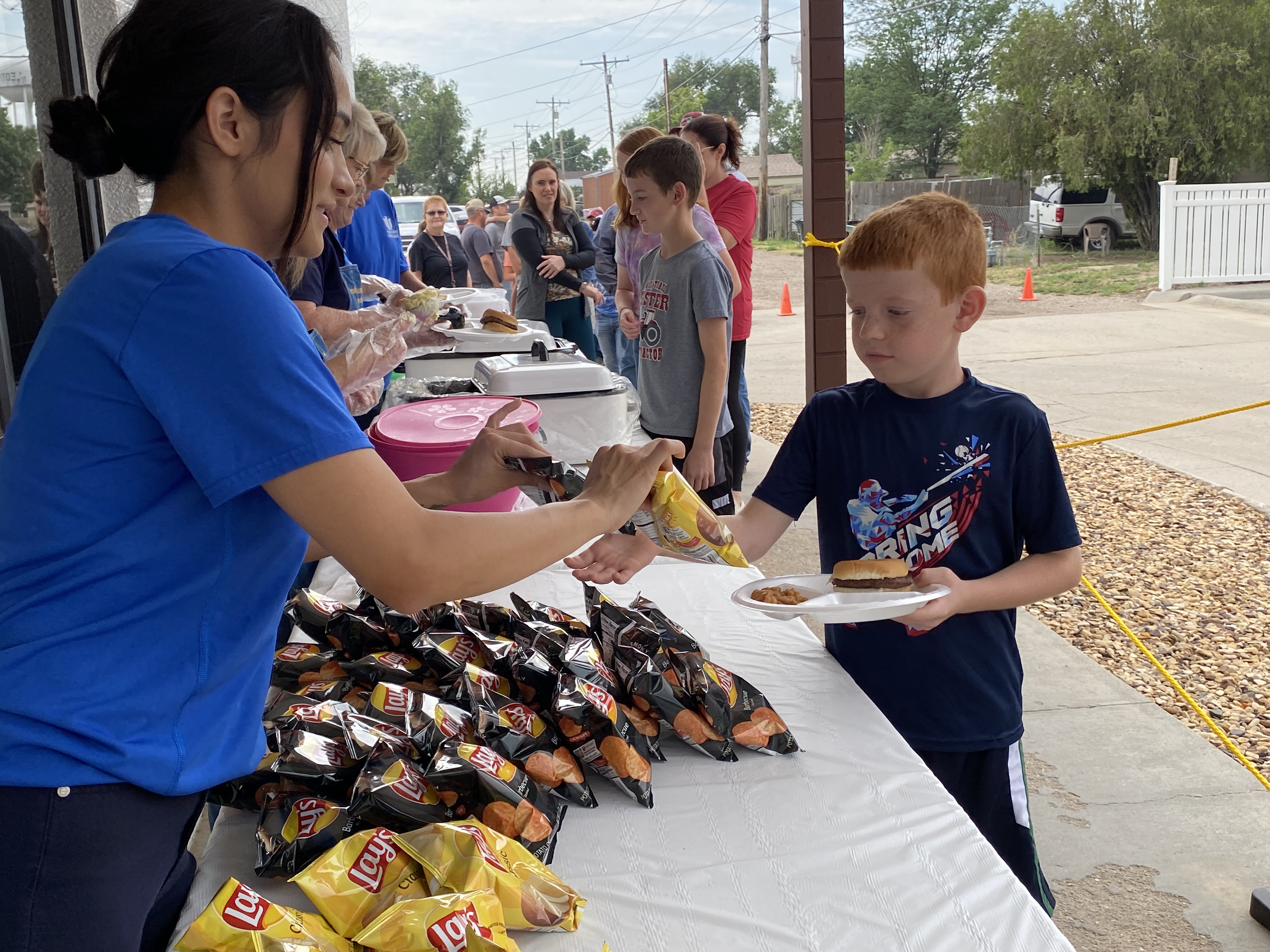 WSB staff member serving food at BBQ