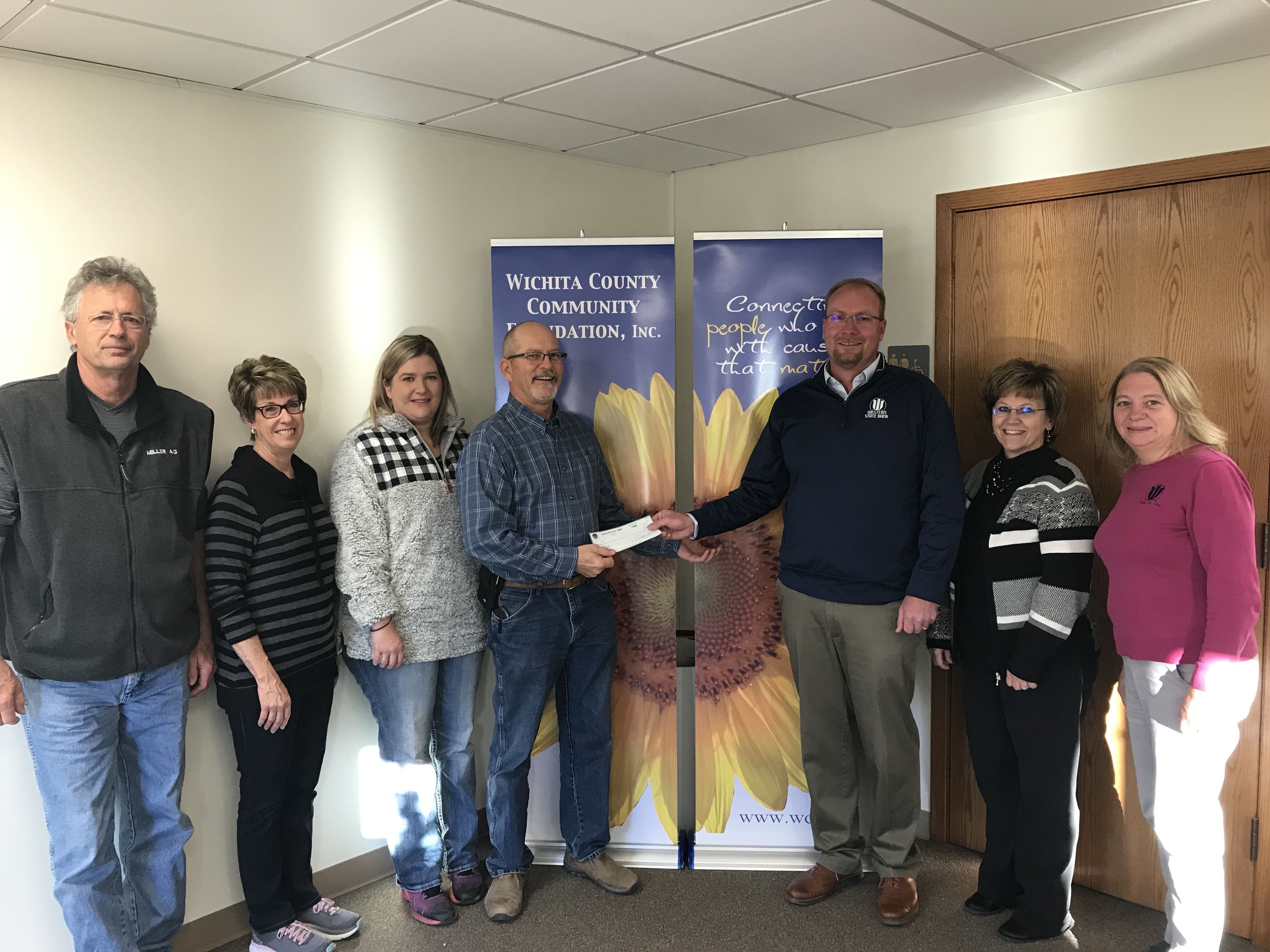 Photo of Leoti employees presenting a check to foundation.