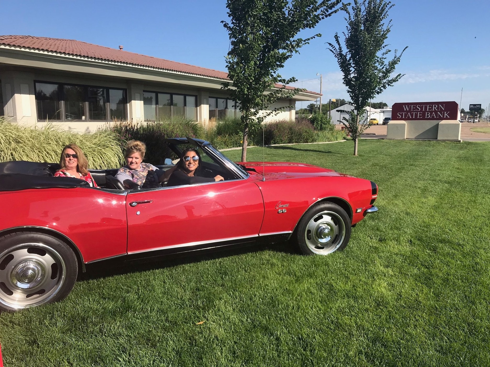 Scott City employees sitting inside Camaro.